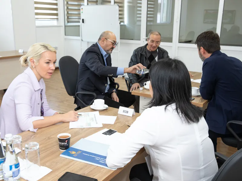 Group of people sitting on desks in a business meeting