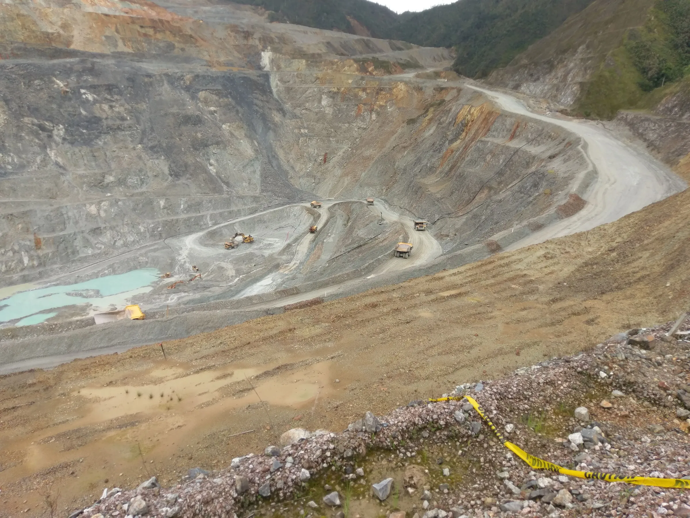 picture of open pit mine with vehicles